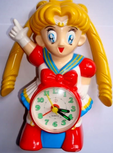 A bootleg Sailor Moon clock; she is pointing in the air and there is an analog coming from her torso