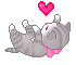 grey tabby kitten on her back like a baby reaching up to play with a floating heart
